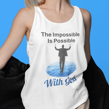 Lightweight Bella+Canvas tank top made from preshrunk cotton with “Impossible Man” design message, “The Impossible Is Possible with God,” inspirational apparel calling believers to step out in faith and walk with God into new possibilities, woman in white tank top